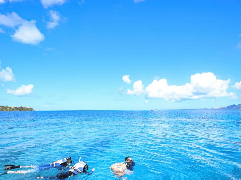 Snorkelers over the reef on the Kerama day trip